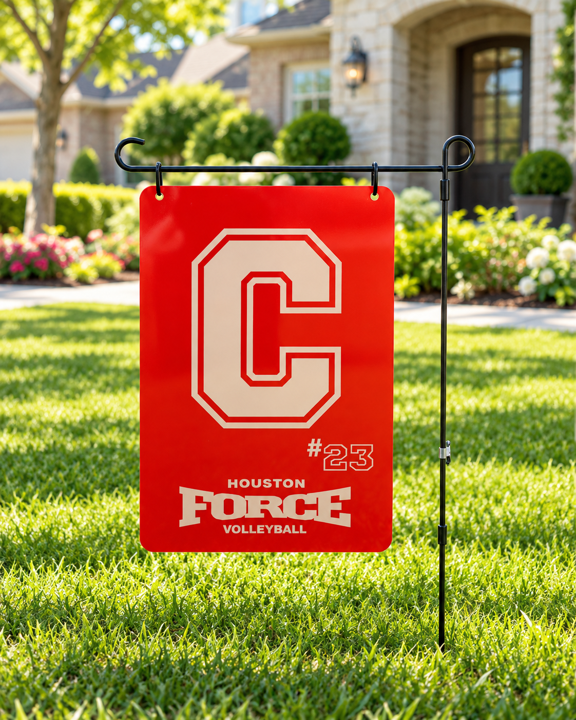 Personalized Houston Force Volleyball red letter C and number 23 sign displayed on a black garden stake in a landscaped front yard