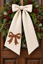 Rustic Christmas wreath with ivory sash and leather bow design