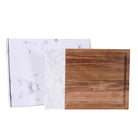 Marble and acacia serving board shown blank with protective product packaging