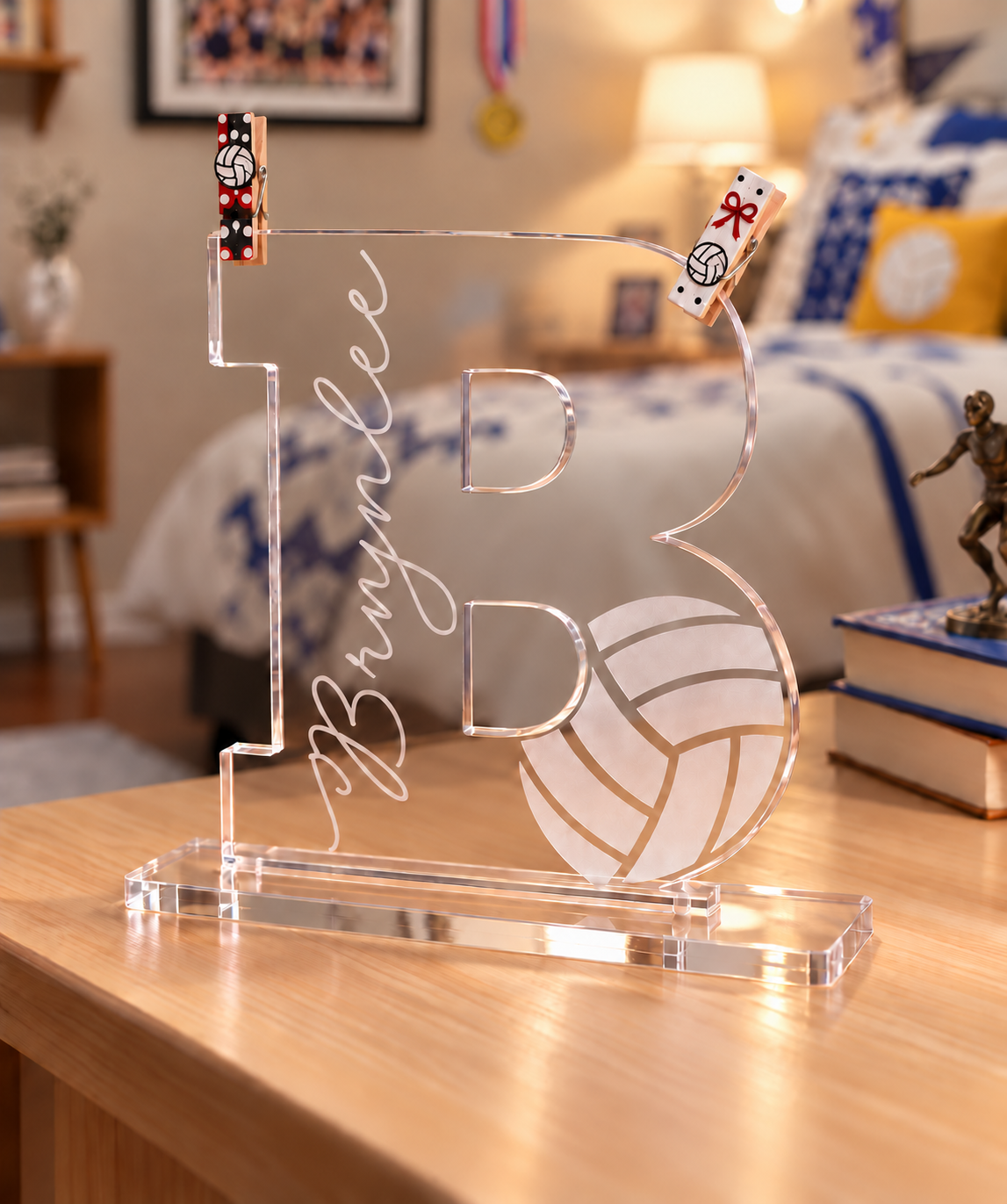 Personalized acrylic volleyball letter shown with two red and black volleyball trading clothespins as a display idea.