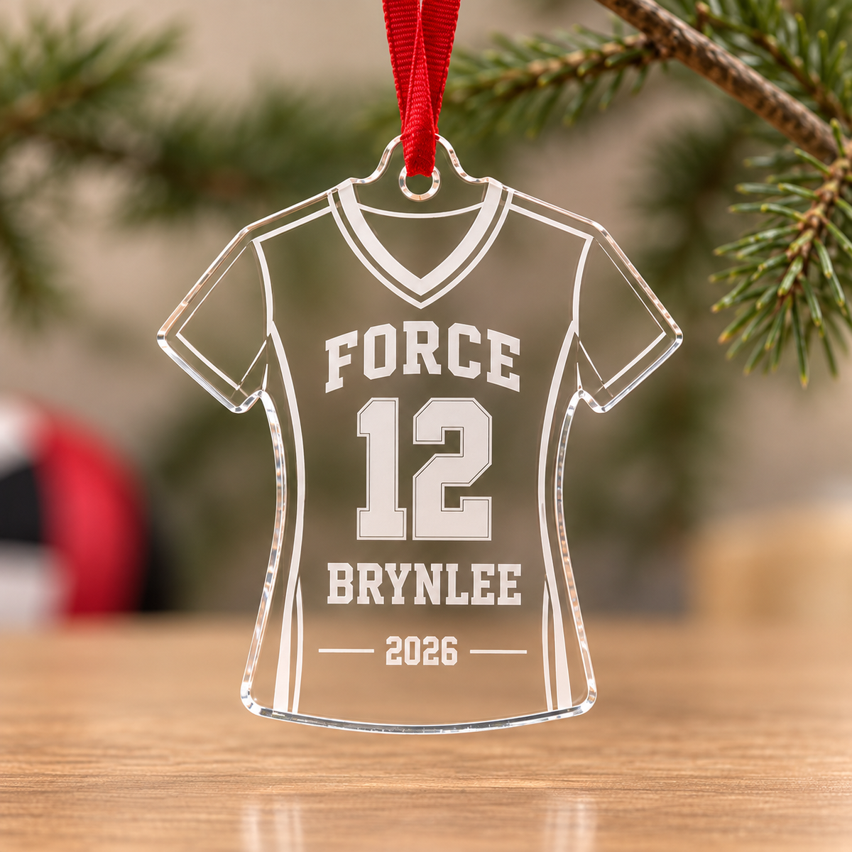 Clear acrylic Force volleyball jersey ornament engraved with Brynlee, number 12 and 2026, with red ribbon