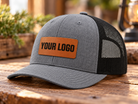 Richardson 112 Heather Grey/Black hat with centered Rawhide rectangle leatherette patch and sample YOUR LOGO engraving