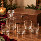 Name-only engraving example: THE THOMPSONS engraved consistently on the decanter and four rounded rocks glasses, beside the unengraved XL wooden keepsake box with visible latch.