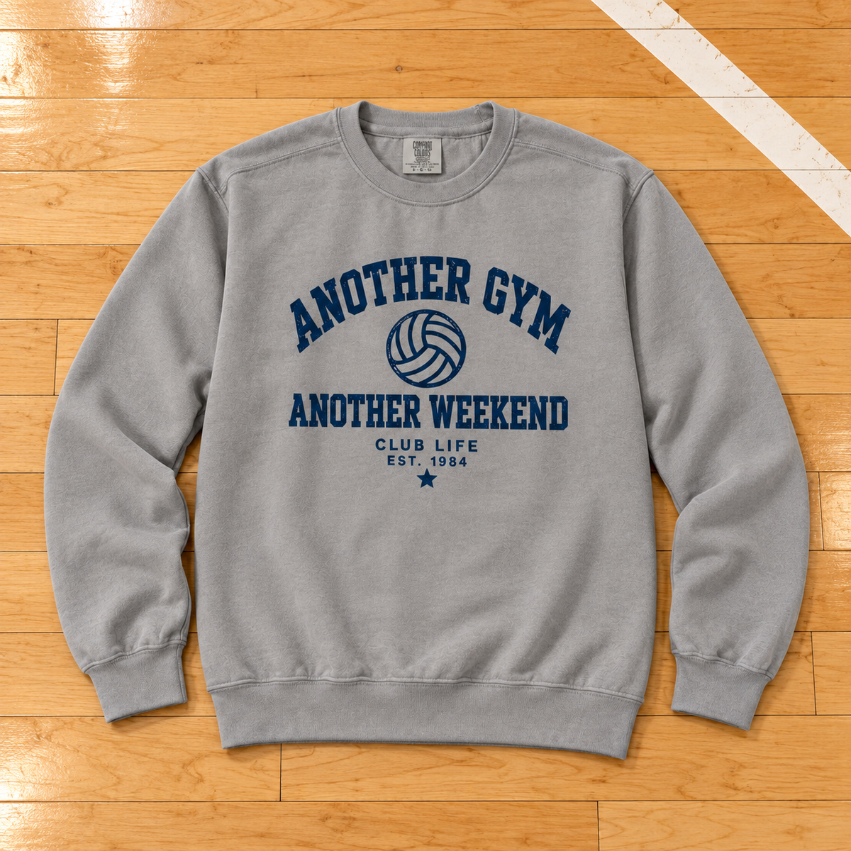 Another Gym • Another Weekend Vintage Crewneck lying flat on a wooden volleyball court, photographed directly overhead