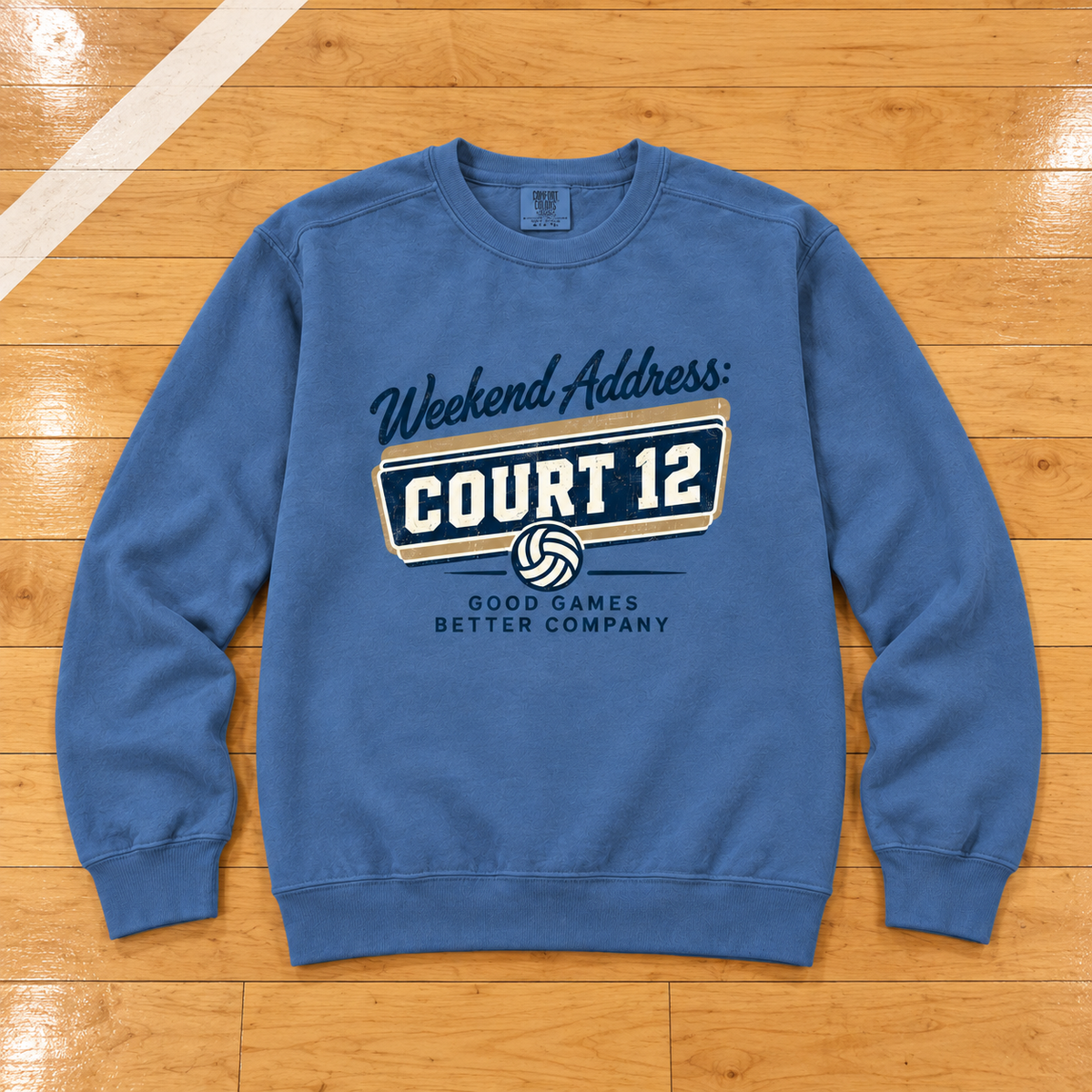 Weekend Address: Court 12 Vintage Crewneck lying flat on a wooden volleyball court, photographed directly overhead