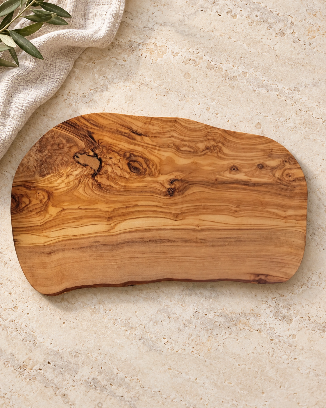 Personalized Natural Olive Wood Charcuterie Board in a warm naturally lit setting