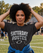 Saturday Routes Flag Football Tee shown in a natural sports setting